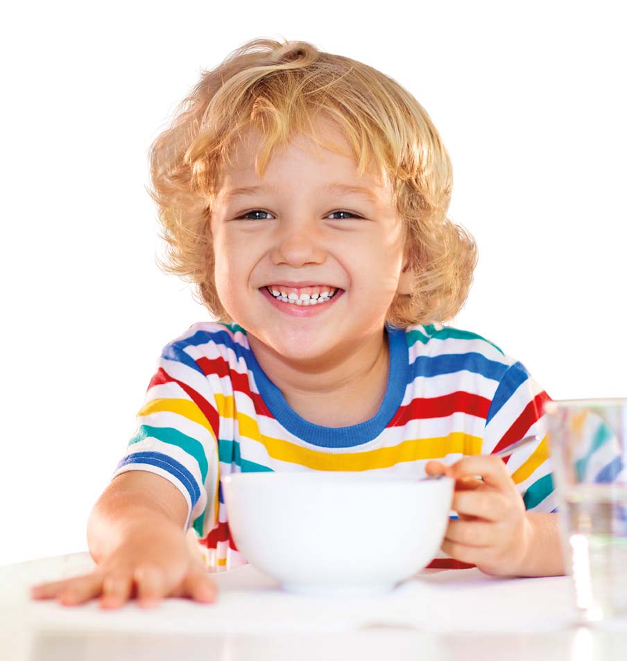 Smiling boy with a cereal bowl