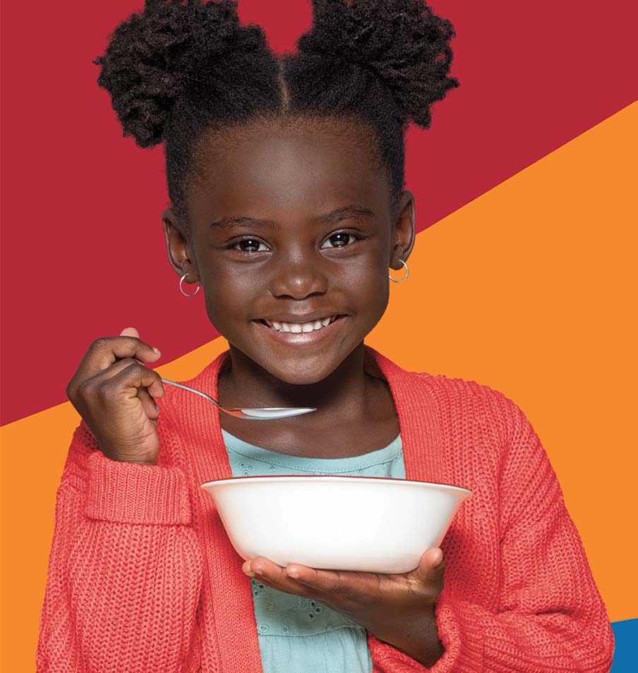 Smiling girl with a cereal bowl